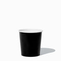 Close-up of 1 Pint black paper to-go containers stacked and ready to serve