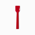 Close-up of red tasting spoons stacked and ready to serve