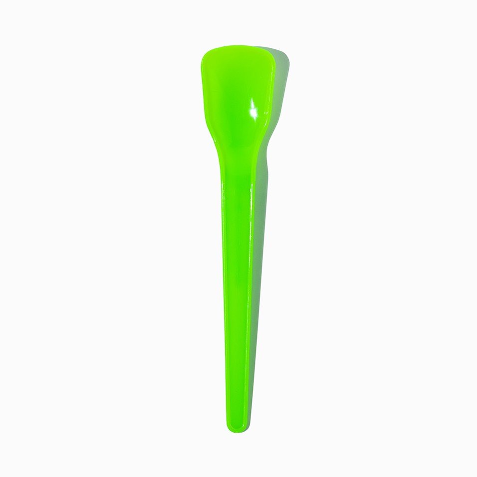 Close-up of green tasting spoons stacked and ready to serve