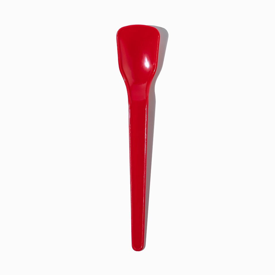 Close-up of red tasting spoons stacked and ready to serve