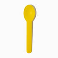 Close-up of yellow tasting spoons stacked and ready to serve